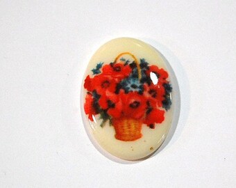 May include: A white oval ceramic cabochon with a printed image of a basket of red flowers.
