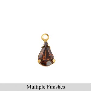 May include: A gold teardrop charm with a brown faceted gemstone.