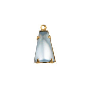 May include: A trapezoidal pendant featuring a translucent, pale blue stone set in a gold-toned metal frame. The setting includes four small prongs securing the stone and a circular loop at the top for attachment to a chain or cord.