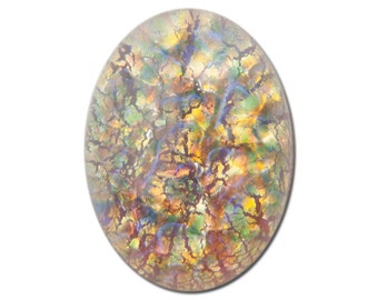 May include: A round, iridescent glass cabochon with a cracked and marbled pattern in shades of brown, yellow, green, and blue.