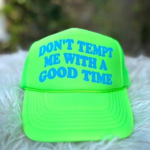 May include: A neon green trucker hat with a blue embroidered message that reads "Don't tempt me with a good time."
