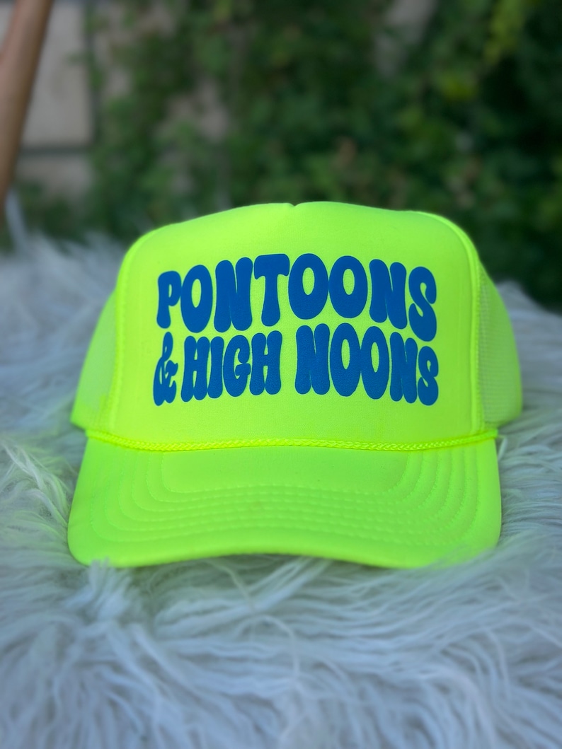 May include: Neon yellow trucker hat with blue text that reads "Pontoons & High Noons".