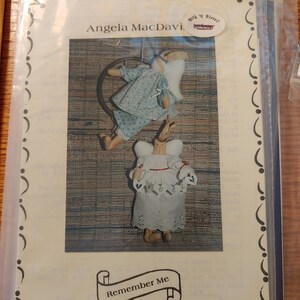 May include: A vintage craft pattern for a doll with the title "Remember Me" and the text "Angela MacDavi Bills 'n Pieces" and contact information for the creator.