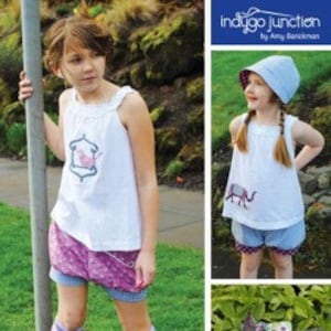 May include: A sewing pattern for a girl's bubble shorts, hat, and shoes. The pattern is called "Bubble Shorts, Hat & Shoesies" and is a Violet Craft Design. The pattern includes a bird and elephant graphic.