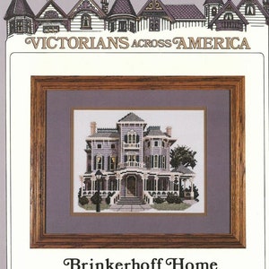 May include: A cross-stitch pattern of a Victorian home with a grey exterior, white trim, and a large porch. The home is surrounded by trees and bushes. The text "Brinkerhoff Home Poughkeepsie, New York" is below the image.