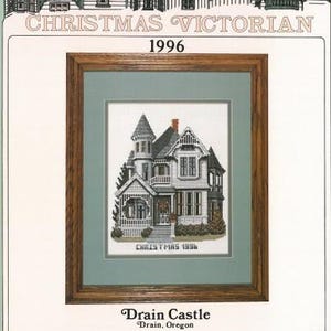 May include: A counted cross-stitch pattern featuring a Victorian house with a Christmas wreath on the door. The pattern is titled "Drain Castle" and is by Debbie Patrick. The pattern is from 1996.