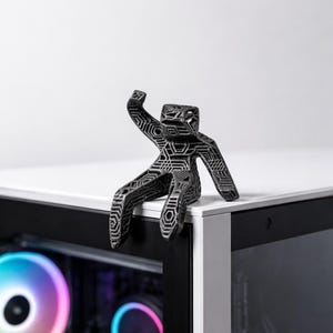 A small statue of Dr. Ryland grace sat atop a minimalist gaming pc.