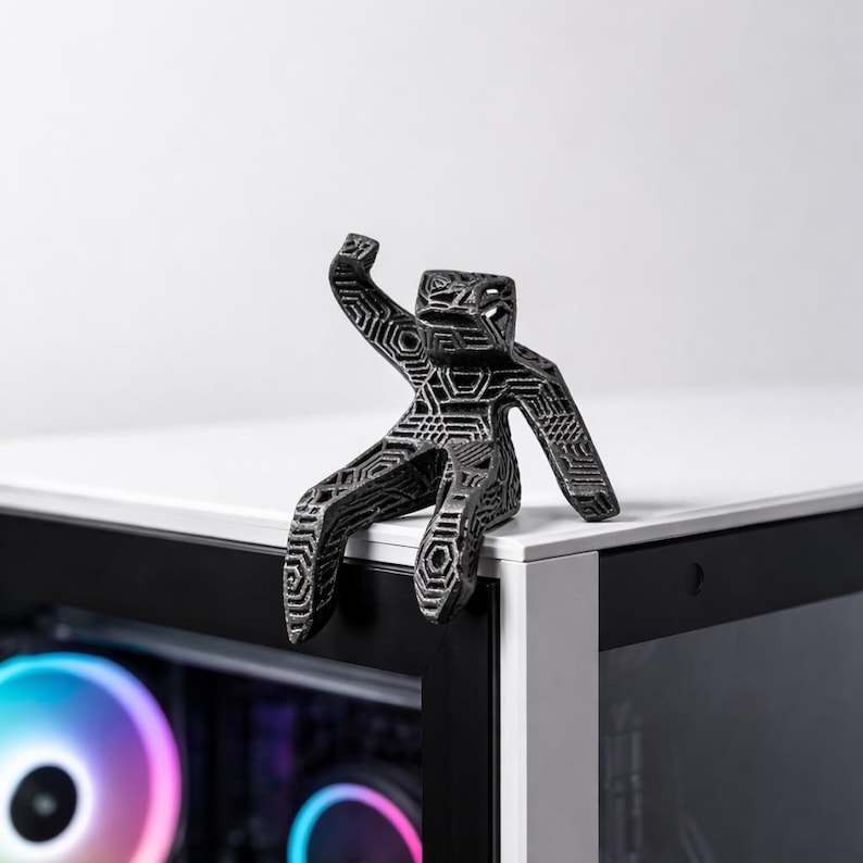 A small statue of Dr. Ryland grace sat atop a minimalist gaming pc.