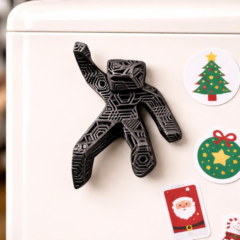 A small figure of Dr. Ryland grace attached to a refrigerator with christmas gift magnets.