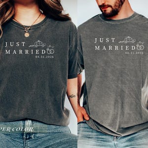 May include: Two gray t-shirts with the text "JUST MARRIED" and the date 04.31.2026. The shirts feature a car and wedding rings graphic. The bottom of the image has the text "PEPPER COLOR".