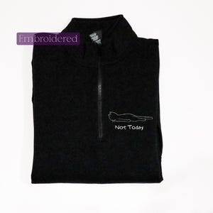 a black shirt with a picture of a cat on it