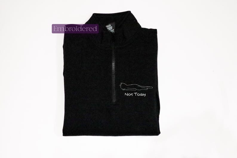 a black shirt with a picture of a cat on it