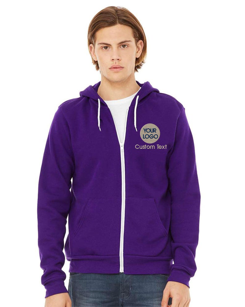 a young man wearing a purple zip up hoodie