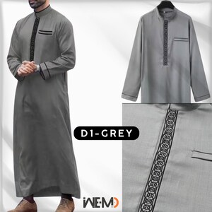 Men’s grey thobe worn by model, featuring black embroidered front panel, chest pocket and detailed cuffs. Classic Arabic thobe for men, also called Islamic thobe, Saudi thobe, jubbah, jubba or dishdasha. Modest Muslim clothing ideal for daily wear, prayer, Ramadan and Eid.