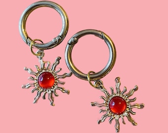 Pair of Sun Charm Red Stone, accessory for walking sticks, phones and bags.  Great idea for keys, trainers and boots.