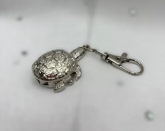 Watch charms, silver turtle with numerical face. Attach to your walking stick or bags.