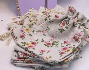 Red & pink flower detail on a linen drawstring bag, lightweight and strong. Perfect for any kids/adults gifts/presents. Small 13 x 9cms