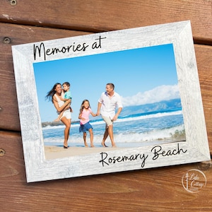 May include: A white-washed wooden picture frame with a family photo at the beach. The frame is 5 x 7 inches and has the words "Memories at Rosemary Beach" written on it. The top of the frame reads "Personalized Picture Frame".