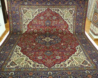May include: A traditional Persian rug with a red, blue, and ivory color scheme. The rug features intricate floral and geometric patterns.