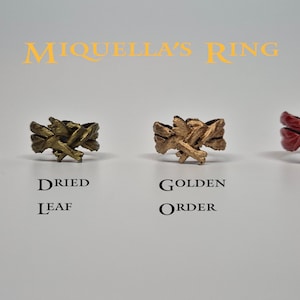 May include: Four different coloured rings with a unique design. The rings are labelled "Celestial Grace", "Dried Leaf", "Golden Order", and "Blood Pact".