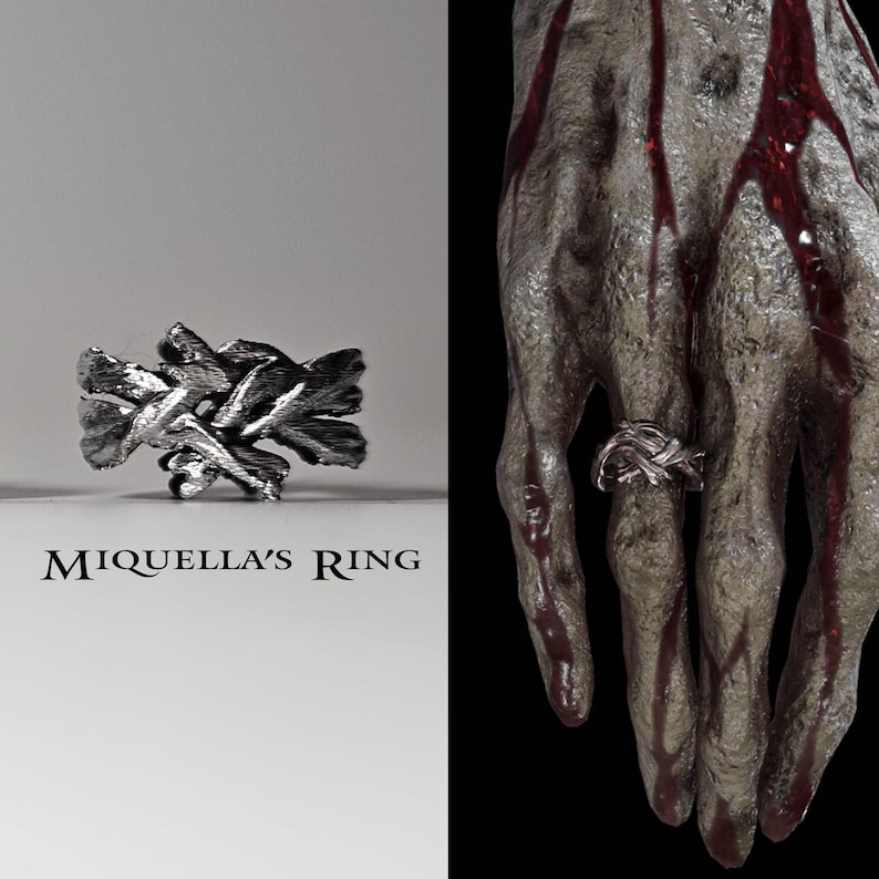 May include: A silver ring with a twisted, knot-like design. The ring is shown on a white background and on a hand with red markings.