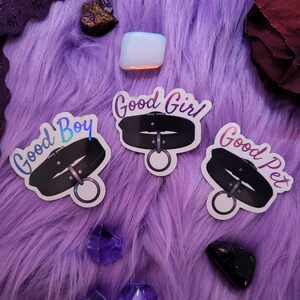 May include: Three holographic stickers with black and silver collars and the text "Good Boy", "Good Girl", and "Good Pet".