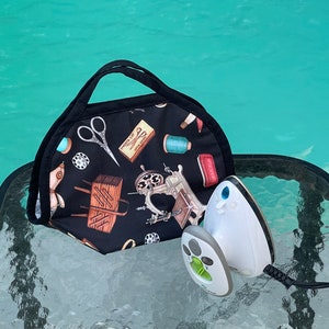 Miniature iron carrier made with cotton and heat resistant teflon coated quilted ironing pad inside, with magnetic closure and handles