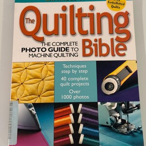 May include: The Quilting Bible: The Complete Photo Guide to Machine Quilting, expanded edition book cover with a yellow quilting machine foot, spools of thread, and an iron. The book cover features the title "The Quilting Bible" in red and white text and the subtitle "The Complete Photo Guide to Machine Quilting" in black text.
