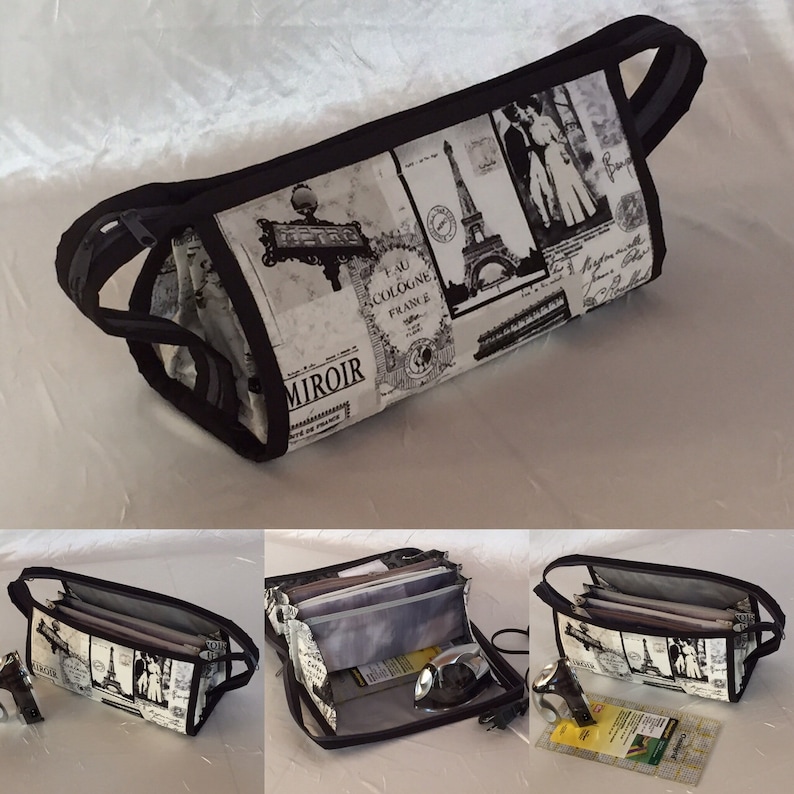 May include: A black and white fabric zippered pouch with a Parisian theme. The pouch is open to reveal multiple compartments and a black and silver iron.