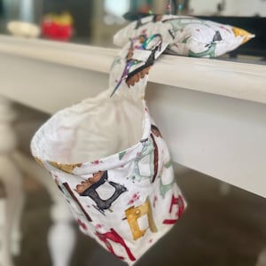 Pincushion with trash catcher and bridge for scissors