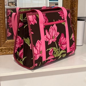 Ultimate carry all bag for quilting, sewing and crafts, 18 pockets, back pocket with sleeve for roller cart, ironing pad on flap side