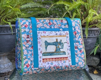 Ultimate Carry All Bag for sewing, quilting, beading and other crafts, 18 pockets, roller cart sleeve, ironing pad on a flap side