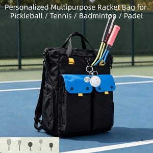 May include: A black backpack with two blue front pockets, yellow accents, and top handles. It holds three rackets and a keychain with a white pickleball. The text reads: Personalized Multipurpose Racket Bag for Pickleball / Tennis / Badminton / Padel.
