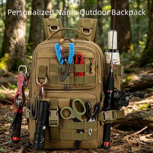 May include: A tan tactical backpack with the text Personalized Name Outdoor Backpack. The bag features multiple external straps and pockets holding various tools, including a black flashlight, fishing pliers, scissors, and a fishing rod.