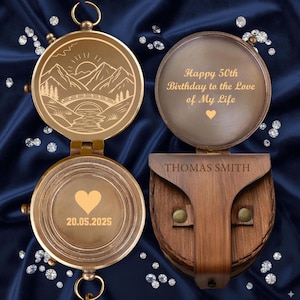 May include: A personalized brass compass with an engraved mountain and bridge scene. The open compass reveals the message "Happy 50th Birthday to the Love of My Life" and the name "THOMAS SMITH". The bottom of the compass has a heart and the date 20.05.2025.