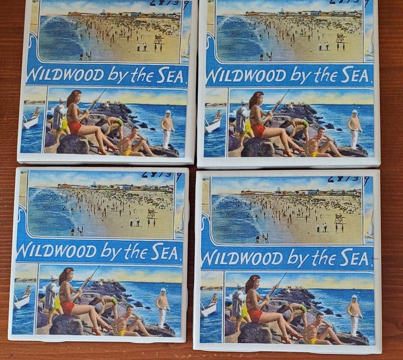 May include: Four square ceramic coasters with a vintage postcard design featuring a beach scene with people and the text "WILDWOOD by the SEA".