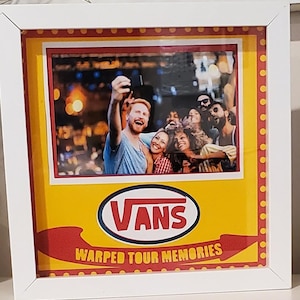 May include: White framed picture featuring a group of people taking a selfie. The picture has a yellow and red border with the Vans logo and the text "Warped Tour Memories".