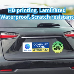 May include: A blue and white rectangular car magnet with the text "COMPANY NAME" and a phone number. The magnet also has a green and yellow circle with the text "CUSTOM CAR MAGNET". The magnet is on the back of a black car.