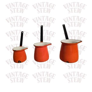 May include: Three vintage orange enamelware pots with black handles and white rims. The pots are different sizes and have a spout for pouring. The text "VINTAGE STEW" is repeated in the background.
