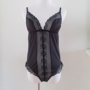 80s black teddy, sexy lace empire bodice + middle lace insert front center, scalloped lace at hips. Silky stretch poly-36 bust.