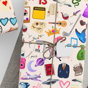 May include: Three gift wrap designs with a white background and colorful illustrations. The designs feature various icons, including butterflies, hearts, musical notes, a crown, a guitar, a camera, a plane, a UFO, a suitcase, a fox, a clock, a pair of sunglasses, a dice, a money bag, a snake, a wine glass, a golf club, a calendar, a book, a suit, a typewriter, and the text "Love Station" and "87 13".