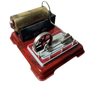 May include: A vintage toy steam engine with a red base, a brass cylinder, and a black housing. The engine features a silver flywheel and connecting rods, with a silver pipe extending from the cylinder.