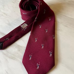 Vintage Excello Cravats Tie with Tennis Theme in Burgundy Polyester - c. 1960s