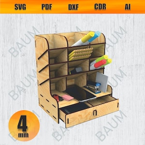 May include: A wooden desk organizer with multiple compartments and a drawer. The organizer holds pens, pencils, a smartphone, and other office supplies. The wood is light-colored, and the design includes the text "SVG PDF DXF CDR AI" at the top.