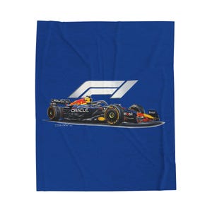 May include: A blue blanket featuring a Formula 1 race car design. The car is black with red and yellow accents, and the blanket includes the F1 logo and sponsor logos. The blanket is a solid blue color.