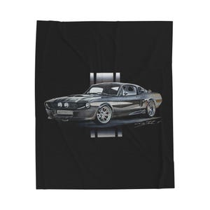 May include: A black blanket featuring a detailed illustration of a classic gray sports car. The car has two headlights, silver rims, and a racing stripe. The blanket is made of a soft material.