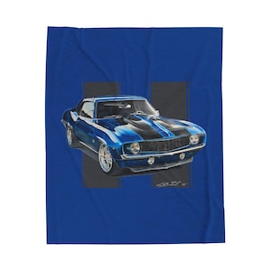 May include: A blue blanket featuring a detailed illustration of a classic blue sports car with black racing stripes. The car is set against a blue background with two vertical gray stripes.