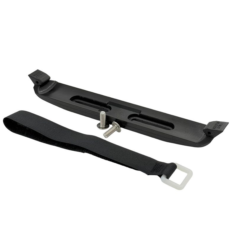 May include: A black plastic battery hold-down bracket with a black strap and two silver screws. The bracket has a curved design with slots and raised ends. The strap has a white square buckle.