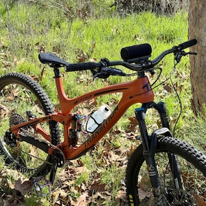 Overall picture of mountain bike with water bottle and speaker mounted. Ready to ride.