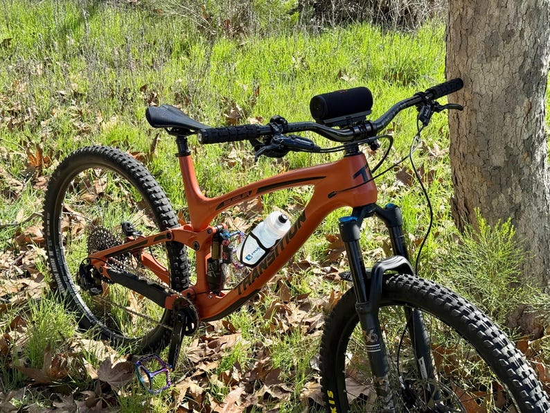 Overall picture of mountain bike with water bottle and speaker mounted. Ready to ride.